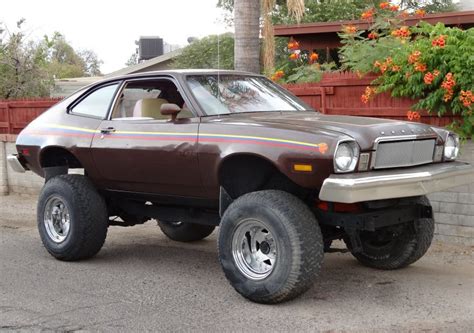 picture of a brown ford pinto with a 4x4 lift kit